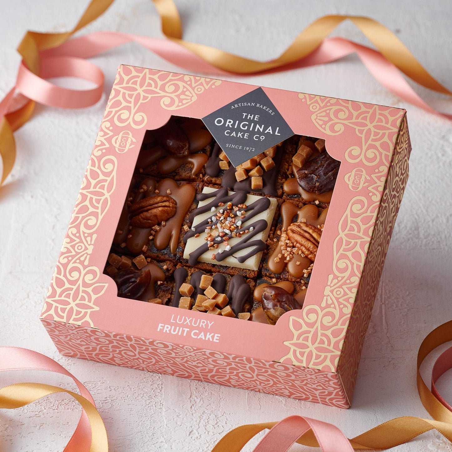 a salted caramel and date cake selection in a peach gifting box sold by the original cake company