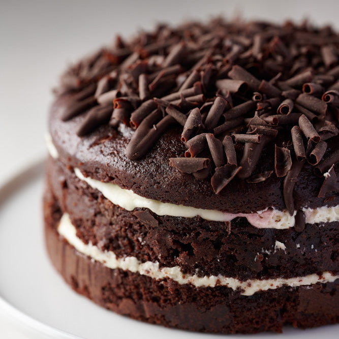 black forest cake with frosting, cherry jam and dark chocolate