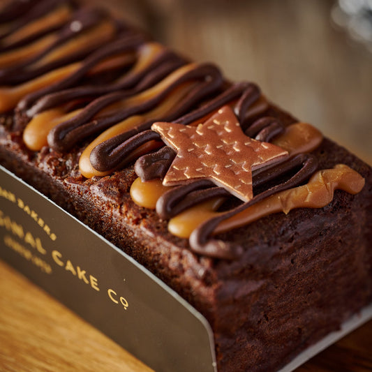 Chocolate cake with star decoration on a wooden surface