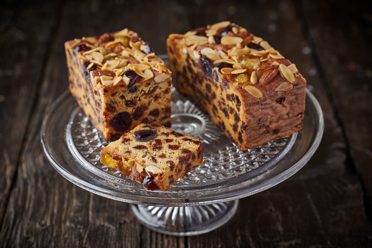 Fruit cake topped with cherries and almonds