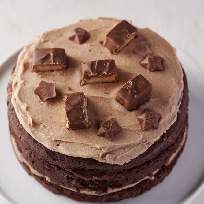 6 inch Milky Way chocolate cake topped with Milky Way bars and milky stars