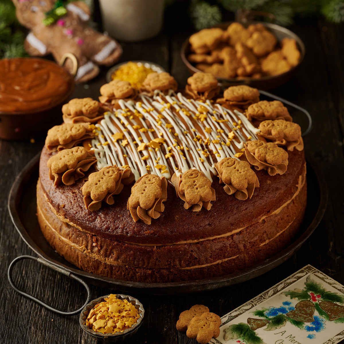 gingerbread cake with ginger frosting finished with mini gingerbread man biscuits