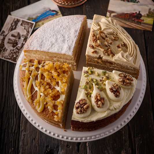 assorted slices of cake including coffee and walnut, lemon drizzle, carrot cake and victoria sponge