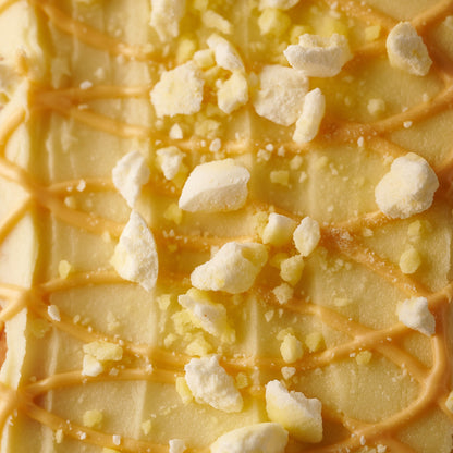 close up of orange frosting and crushed meringue on our st clements loaf cake