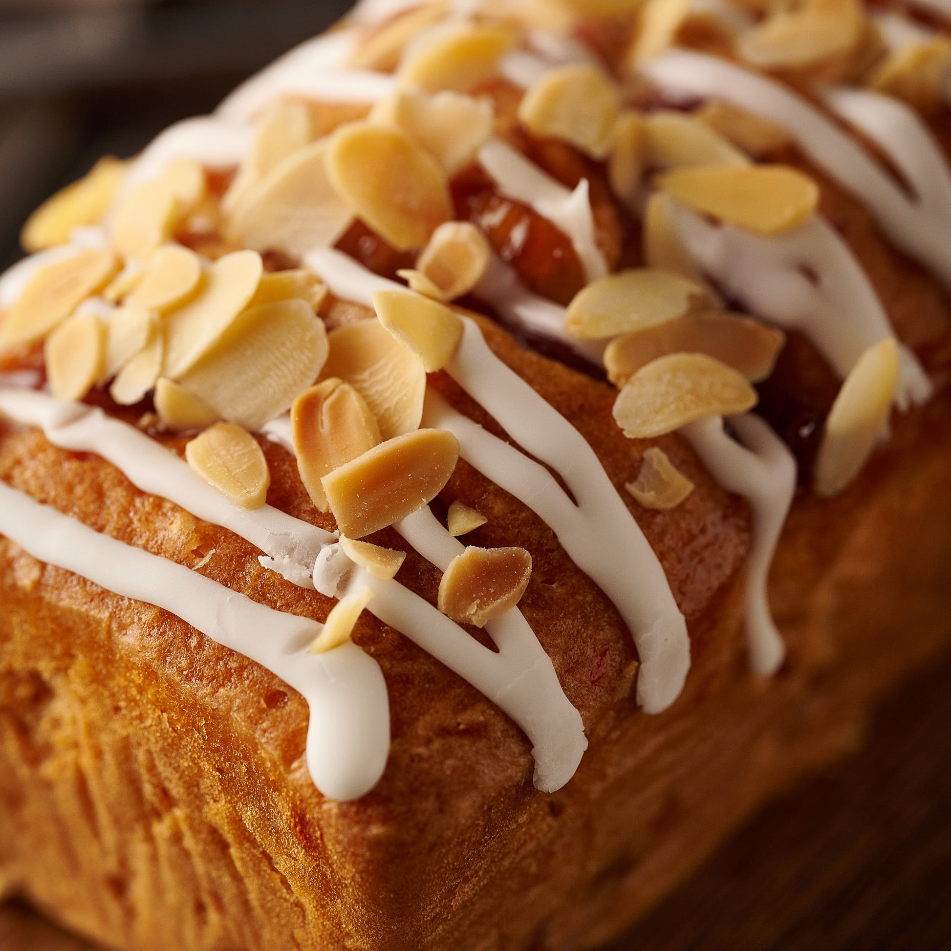 cherry bakewell cake with icing and flaked almonds