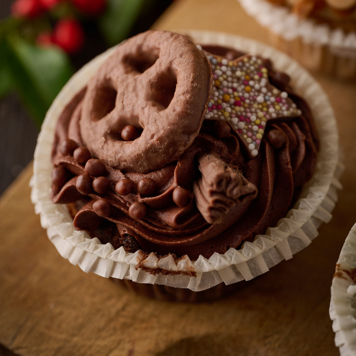 chocolate cupcake topped with biscuit, flake and candy chocolate star. 