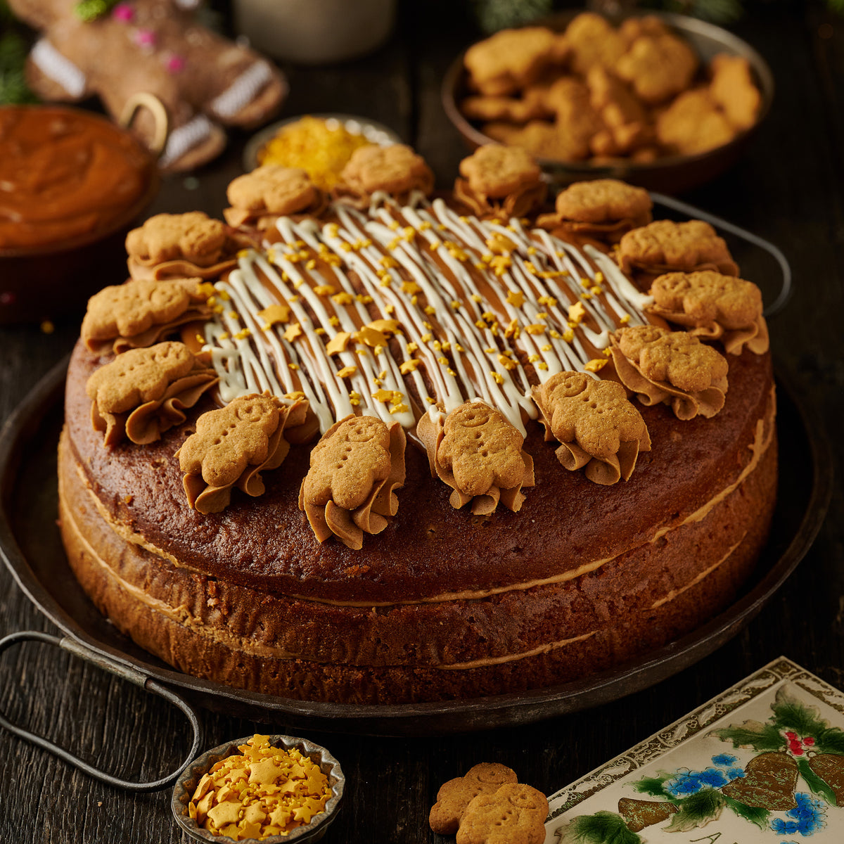 triple layered gingerbread cake finished with mini gingerbread man biscuits