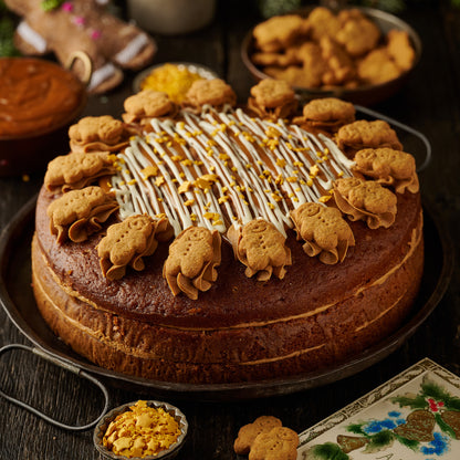 triple layered gingerbread cake finished with mini gingerbread man biscuits