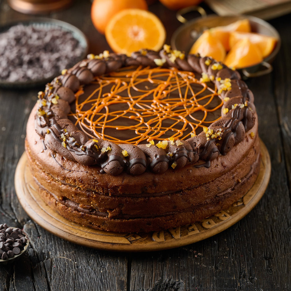 sponge cake made with ornage sponge, filled with chocolate orange frosting, finished with chocolate ormage swirls and candies orange pieces.