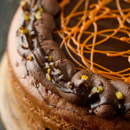close up of our jaffa cake inspired cake with orange sponge, chocolate ornage frosting and finished with candied orange pieces. 