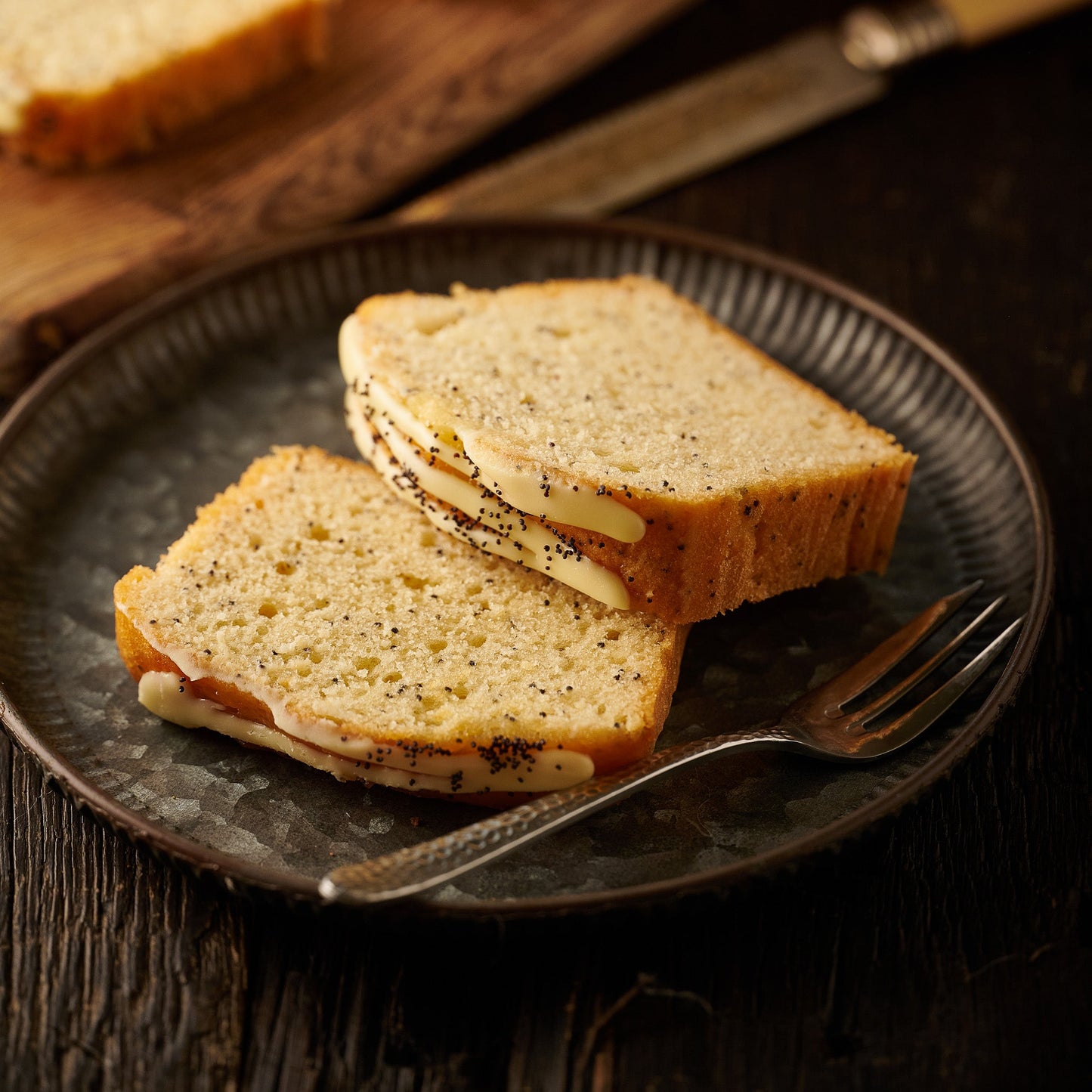 two slices of lemon and poppyseed loaf cake on a plate