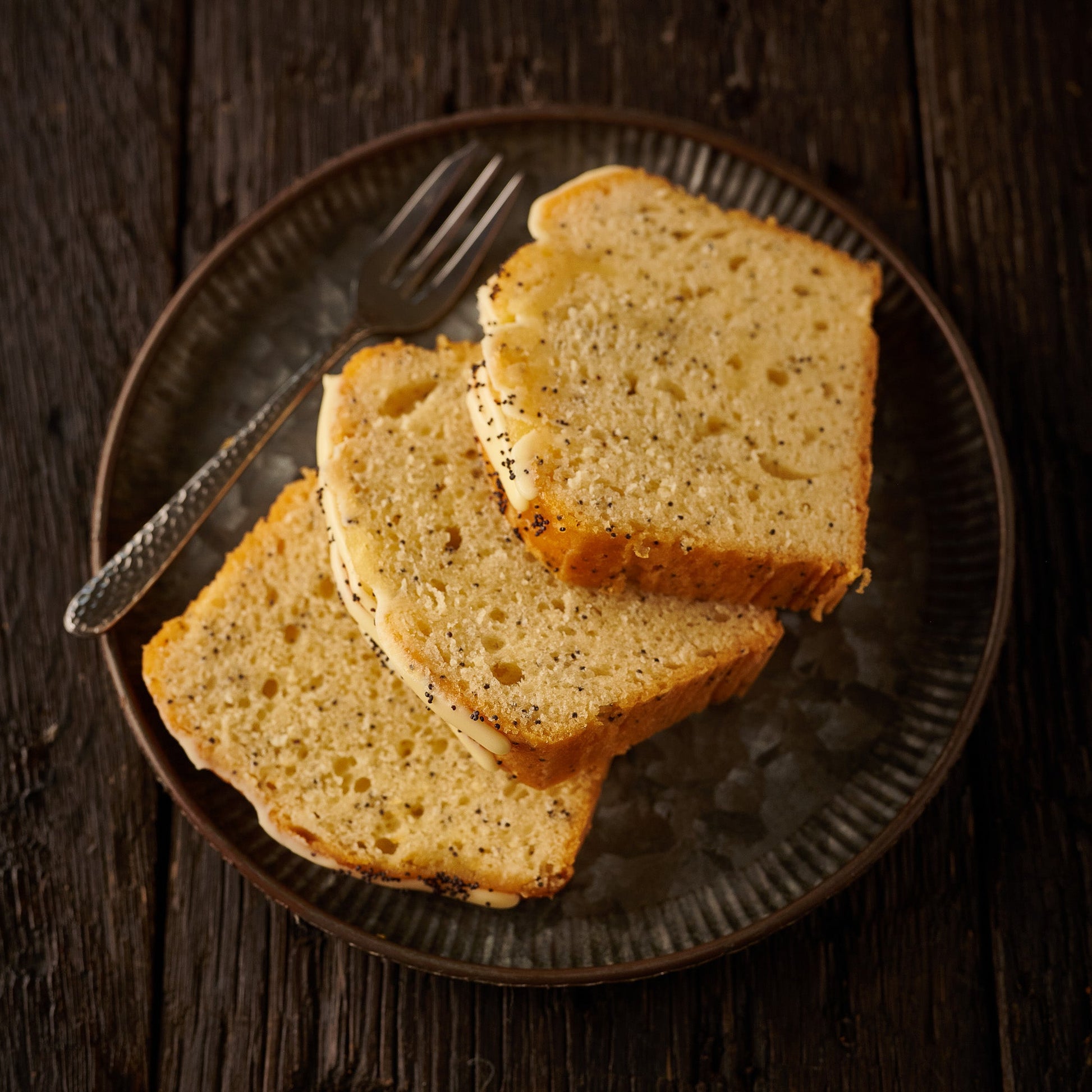 three slices of lemon poppyseed cake on a plate