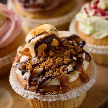 smore cupcake topped with caramel, chocolate, biscuit crumb and finished with a toasted marshmallow 
