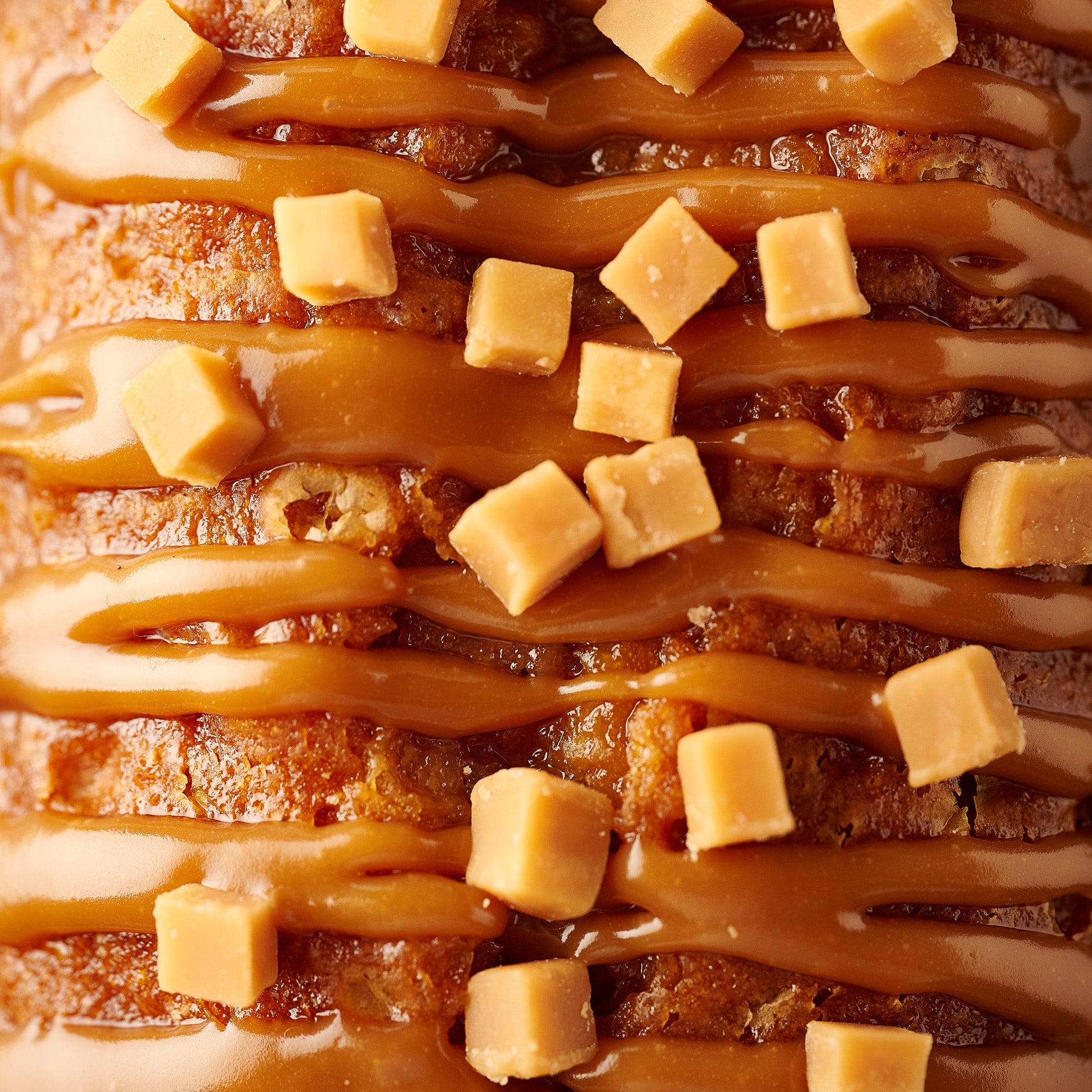 sticky toffee loaf cake close up with caramel and fudge